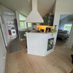 Kitchen with island, bedroom and laundry room visible.