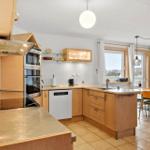 Kitchen with wooden cabinets, sink, and view of water