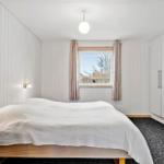 Bedroom with bed, window, and closet.