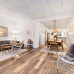 Living and dining area with wooden floor and modern furnishings.