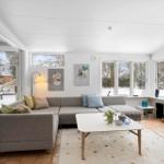Living room with sofa, table, and windows to snow