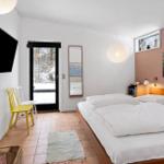 Bedroom with bed, TV, and view of snow