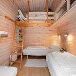 Room with two beds and a loft bed with ladder.