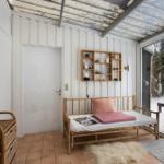 Room with bamboo bed, wall shelf, and terrace with snowy outdoor area.