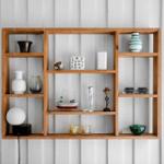 Wooden shelf on white wall with vases, ship model, and decor items.