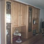 Holzschrank mit Glasfronten und Fernseher auf Ständer