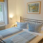 Schlafzimmer mit Doppelbett, Fenster und Nachttischen.