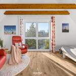 Schlafzimmer mit Blick auf die Landschaft, rotem Sessel und Bett.