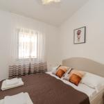 Bedroom with bed, window, and nightstand