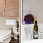 Bad mit Whirlpool, Toilette und Holzdecke. Weißer Whirlpool mit Wein und Pflanze.