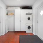 Laundry room with washer and dryer, closet, and tile floor.