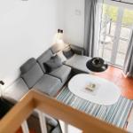 Living room with gray sofa, white table, and terrace door.