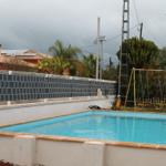 Pool mit Spielplatz und Umzäunung im Hintergrund