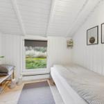 Bedroom with bed, window, and wall art.