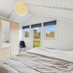 Bedroom with double bed, wardrobe, and windows to the garden.