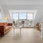 Living room with sofa, table, and balcony view