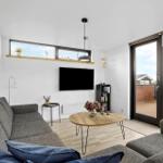 Living room with sofa, TV, and terrace door.