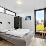 Bedroom with bed, wardrobe, and door to the garden.