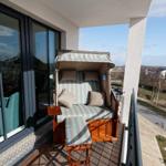 Balcony with beach chair and view of residential area.