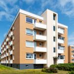 Moderne Wohnanlage mit Balkonen und grünem Umfeld.