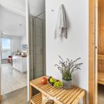 Sauna mit Holzbank und Handtüchern. Blick in Wohnbereich mit Balkon.