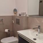 Bad mit Waschbecken, Toilette und Spiegel mit Beleuchtung