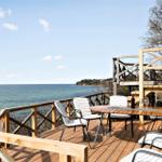 Deck with table and chairs overlooking the sea at the coast.