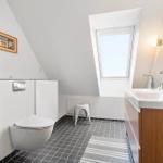 Bathroom with skylights, sink and toilet