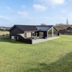 Modern wooden cabin with large garden and terrace. View of adjacent houses.