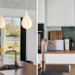 Kitchen with wooden surfaces, white cabinets, and modern pendant lights.