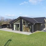Modern house with large glass area and terrace in the green.