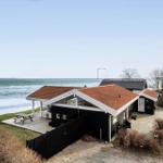 Black beach house with terrace and sea view.