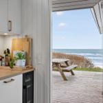 Kitchen with view of wooden terrace and sea