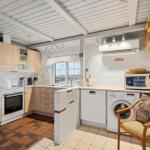 Kitchen with washing machine, dishwasher, and microwave