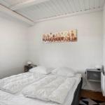 Bedroom with bed, window, and wall art.