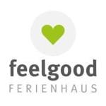Logo von feelgood FERIENHAUS mit grünem Herz in Kreis