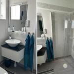 Badezimmer mit Dusche, Waschbecken und Toilette. Blaue Handtücher hängen bereit.