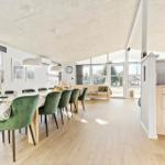 Dining room with green chairs and view into the living room.