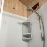Shower cabin with shower head and shelf