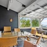 Patio with dining table, chairs, and water view