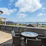 Terrace with seating area and view of sea and landscape