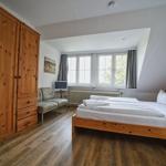 Schlafzimmer mit Doppelbett, Holzmöbel und Fenster mit Blick.