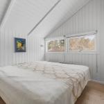 Bedroom with bed, windows and wooden floor