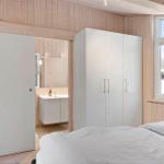 Bedroom with white closet and window view of snow.