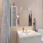 Bathroom with shower, sink, and toilet. Wooden walls and window.