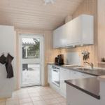 Kitchen with white cabinets, stainless steel countertop, view of snow