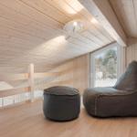 Attic room with wooden ceiling, gray bean bag, and window view