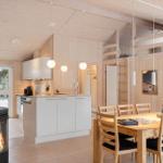 Kitchen with dining table, wooden ceiling, and wood stove in house