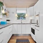 Kitchen with white cabinets, countertop, and window.