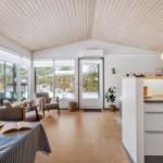 Living area with dining space, kitchen, and large window view of snow.
